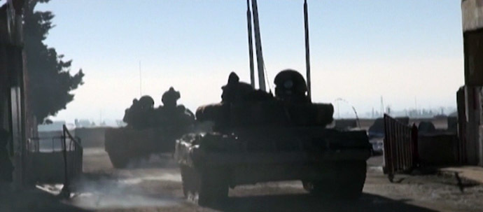 The Syrian army on a mission to force rebels out of the town of Adra. Still from RT video