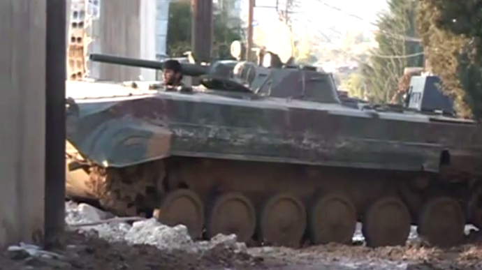 The Syrian army on a mission to force rebels out of the town of Adra. Still from RT video