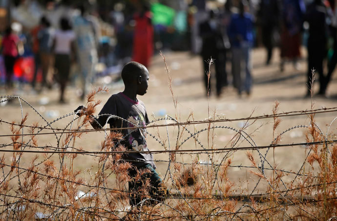 An internally displaced boy walks next to barbed wire inside a United Nations Missions in Sudan (UNMIS) compound in Juba December 19, 2013.(Reuters / Goran Tomasevic)