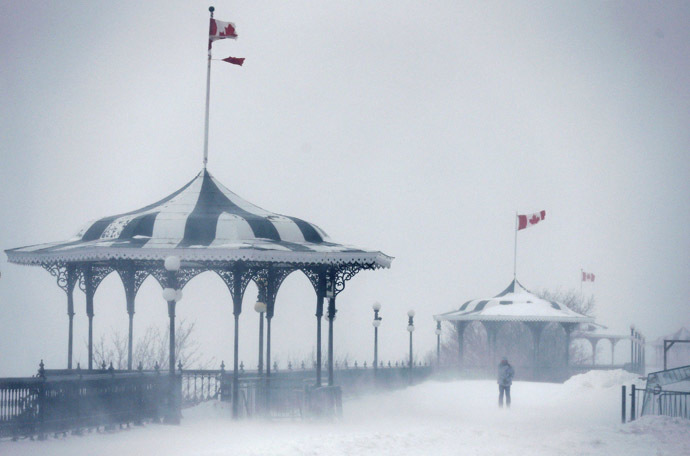 A pedestrian walks on the Terrasse Dufferin during a snowstorm in Quebec City December 22, 2013. (Reuters/Mathieu Belanger)
