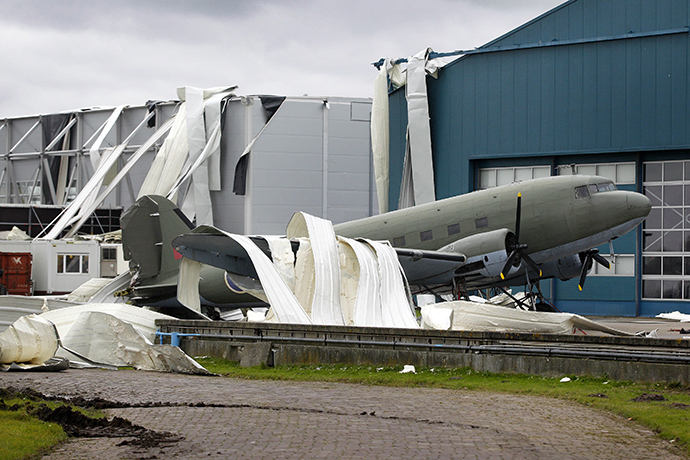 Parts of the roof of the Theatre Hangar are seen on the Dakota airplane after the roof was partially blown away by strong winds at the former airfield in Valkenburg on December 24, 2013. (AFP Photo / Bas Czerwinski)