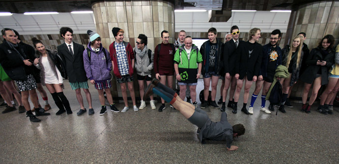 Passengers, not wearing pants, perform as they wait for a subway train during the "No Pants Subway Ride" in Prague January 12, 2014. (Reuters/David W Cerny)