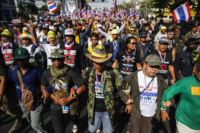 Anti-government protesters link their arms as they march during a rally in central Bangkok January 17, 2014. (Reuters/Athit Perawongmetha)