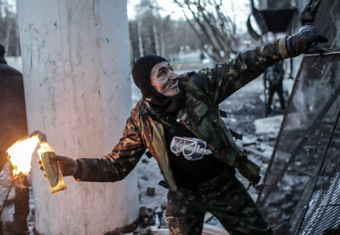 A protester throws a Molotov cocktail at Dynamo stadium in Kiev. (RIA Novosti/Andrey Stenin)
