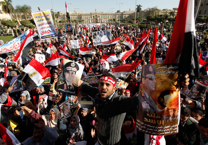 Supporters of Egypt's army chief General Abdel Fattah al-Sisi hold posters of Sisi and wave flags in front of Abdeen Presidential Palace in downtown Cairo, January 24, 2014 (Reuters / Mohamed Abd El Ghany)