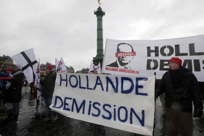 Demonstrators hold a banner which reads, "Hollande Resign" as several thousand people attend the "Journee de la Colere" (Day of Anger) march in protest of France's President Francois Hollande, in Paris January 26, 2014. (Reuters/Philippe Wojazer)