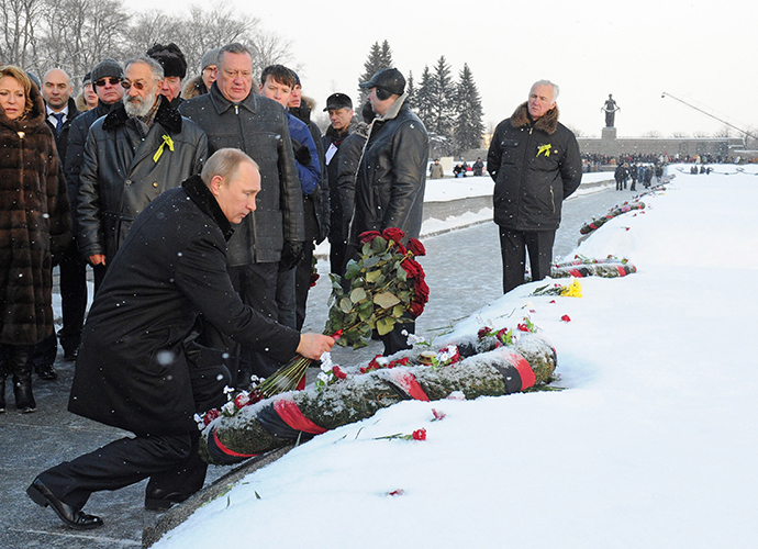 January 27, 2014. Russian President Vladimir Putin, foreground, participates in a wreath-laying ceremony at St. Petersburg's Piskaryovskoye Memorial Cemetery. (RIA Novosti / Michael Klimentyev)