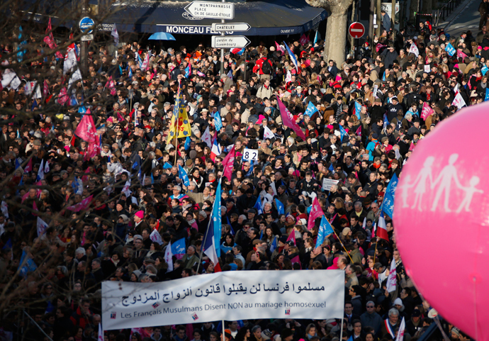 People wave trademark pink, blue and white flags during a protest march called, "La Manif pour Tous" (Demonstration for All) against France's legalisation of same-sex marriage and to show their support of traditional family and education values, in Paris February 2, 2014 (Reuters / Benoit Tessier)