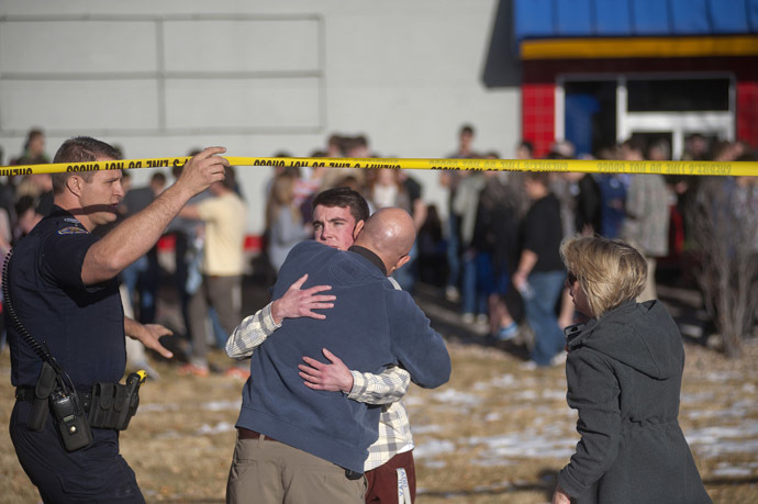 Students gather and reunite with their parents at a fast food joint across from Arapahoe High School, after a student opened fire in the school in Centennial, Colorado December 13, 2013. (Reuters/Evan Semon)