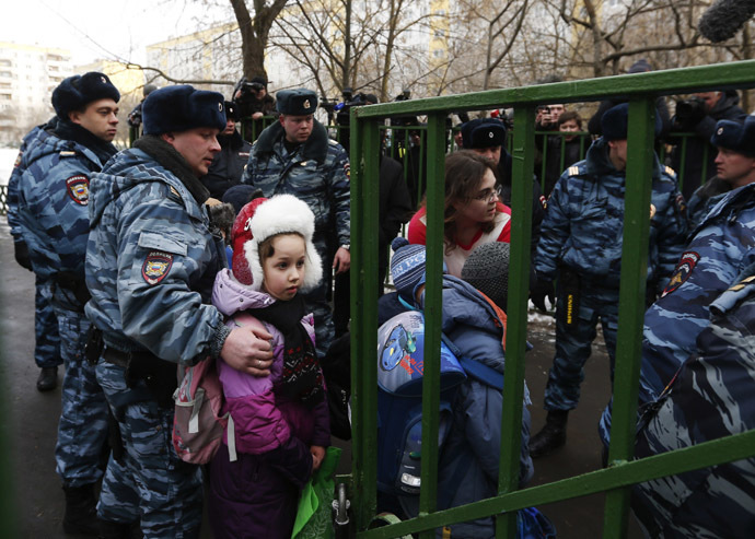 Children walk out of the premises of a high school, where a shooting incident has occurred, on the outskirts of Moscow, February 3, 2014. (Reuters/Maxim Shemetov)