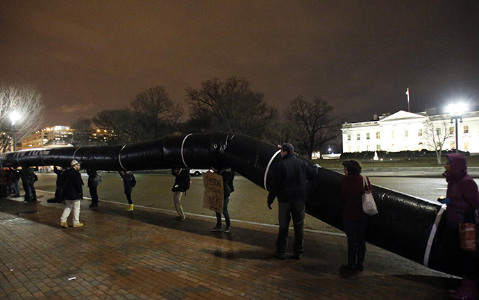 Protesters hold a giant inflated tube during a rally against the Keystone XL oil pipeline outside The White House in Washington February 3, 2014. (Reuters / Yuri Gripas)