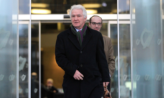 Former chairman and chief executive of Anglo Irish Bank Sean FitzPatrick leaves the Criminal Courts of Justice in Dublin, Ireland on February 5, 2014 after a hearing at the start of his trial. (AFP Photo / Peter Muhly) 