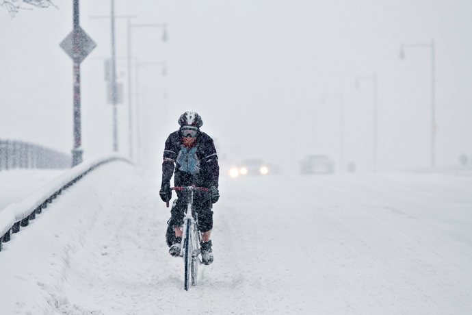 A man rides his bike across a bridge during a winter storm in Boston, Massachusetts, February 5, 2014. (Reuters / Dominick Reuter)
