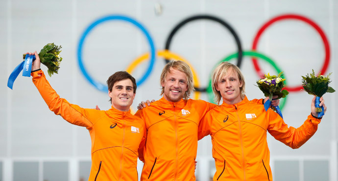 Winner of the men's 500 meters speed skating competition Michel Mulder of the Netherlands (C), second placed Jan Smeekens of the Netherlands (L) and third placed Ronald Mulder of the Netherlands celebrate at the flower ceremony for the event at the 2014 Sochi Winter Olympics, February 10, 2014. (Reuters / Marko Djurica)