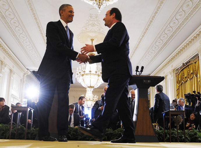 US President Barack Obama shakes hands with French President Francois Hollande during a joint press conference following their meetings in the East Room at the White House in Washington, DC, on February 11, 2014.(AFP Photo /Jewel Samad )