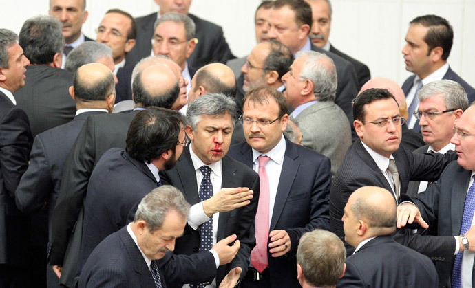 Member of parliament (MP) from the main opposition Republican People's Party (CHP) Ali Ihsan Kokturk's nose bleeds as MPs from the ruling AK Party (AKP) and CHP scuffle during a debate on a draft law which will give the government tighter control over the appointment of judges and prosecutors, at a parliamentary session in Ankara early February 15, 2014 (Reuters / Stringer)