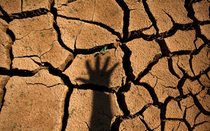 The shadow of a hand is seen on the cracked ground of Jaguary dam during a long drought period that hit the state of Sao Paulo in Braganca Paulista, 100 km from Sao Paulo (Reuters / Nacho Doce)