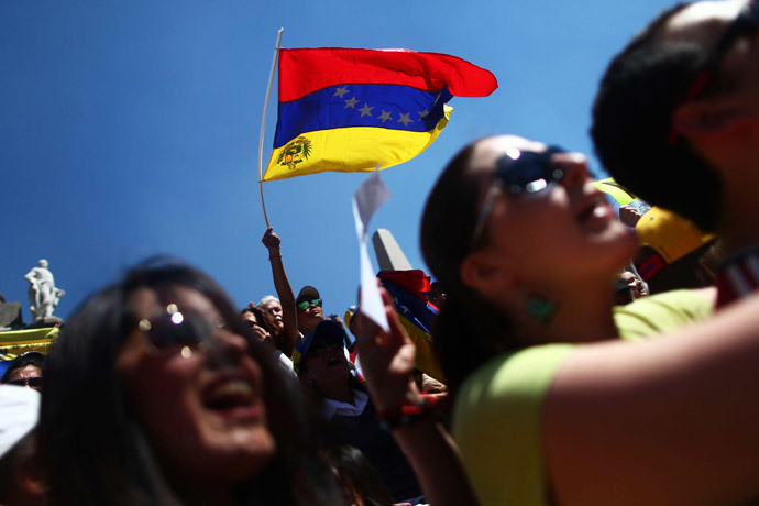 A Venezuelan opposition supporter waves a Venezuelan flag during a protest against Venezuelan President Nicolas Maduro's government at Angel de la Independencia monument in Mexico City, February 16, 2014.(Reuters / Edgard Garrido )