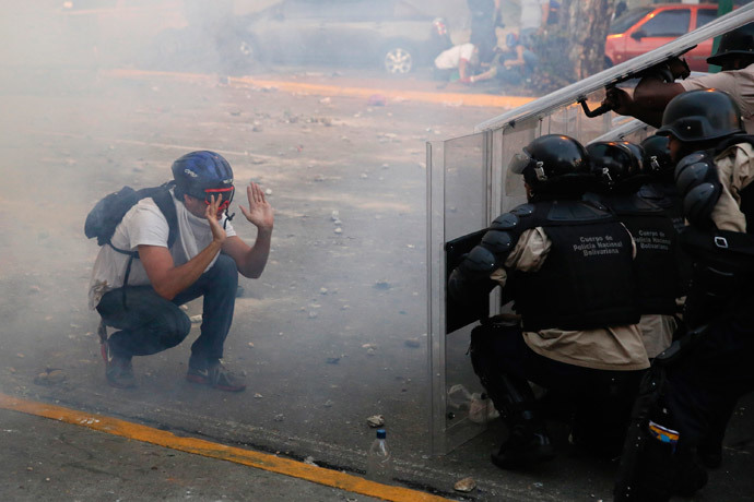 An opposition demonstrator confronts riot police during a protest against President Nicolas Maduro's government in Caracas February 15, 2014. (Reuters / Carlos Garcia Rawlins)