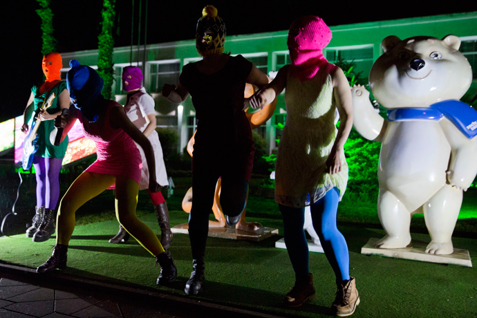 Members of Russian punk group Pussy Riot, Nadezhda Tolokonnikova (front L) and Maria Alyokhina (front R) perform in front of Sochi 2014 Winter Olympic games mascots as they record a video in the Adler district of Sochi, early on February 18, 2014 (AFP Photo / Evgeny Feldman)