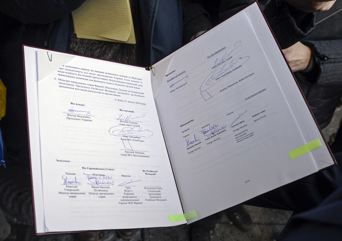 The signed peace deal document between Ukraine's President Viktor Yanukovich and opposition leaders is seen in Kiev, February 21, 2014. (Reuters / Andrew Kravchenko)