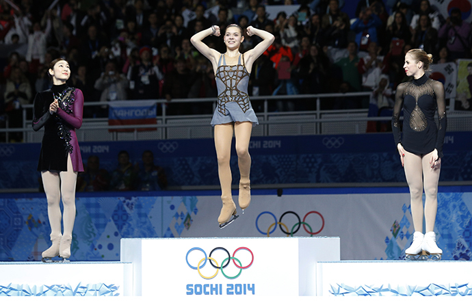 Russia's Adelina Sotnikova celebrates in first place, Korea's Yuna Kim stands in second place and Italy's Carolina Kostner stands in third place on the podium during the Figure Skating Women's free skating Program at the Sochi 2014 Winter Olympics, February 20, 2014. (Reuters / Alexander Demianchuk)