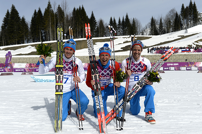 Silver medalist Russia's Maxim Vylegzhanin (7) gold medalist Russia's Alexander Legkov (3) and Bronze medalist Russia's Ilia Chernousov (8) celebrate during the Men's Cross-Country Skiing 50km Mass Start Free Flower Ceremony at the Laura Cross-Country Ski and Biathlon Center during the Sochi Winter Olympics on February 23, 2014, in Rosa Khuto, near Sochi. (AFP Photo / Pierre-Philippe Marcou)