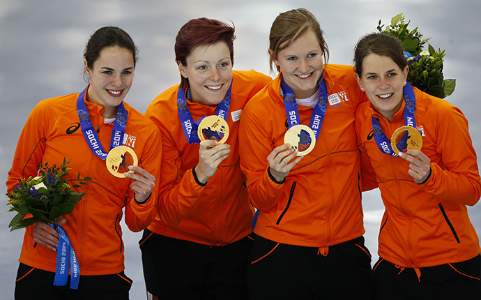 Gold medalists Marrit Leenstra, Jorien ter Mors, Lotte van Beek and Ireen Wust of the Netherlands pose during the victory ceremony for the women's speed skating team pursuit event at the Adler Arena in the Sochi 2014 Winter Olympic Games February 22, 2014. (Reuters / Marko Djurica)