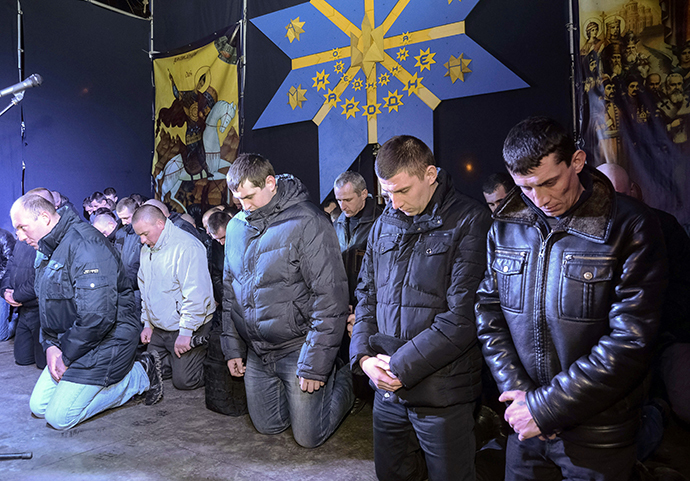 Local riot police kneel as they apologize to Lviv residents for taking part in an operation against anti-government protesters in Kiev but said that they did not beat protesters, during a rally in central Lviv February 24, 2014. (Reuters / Roman Baluk)