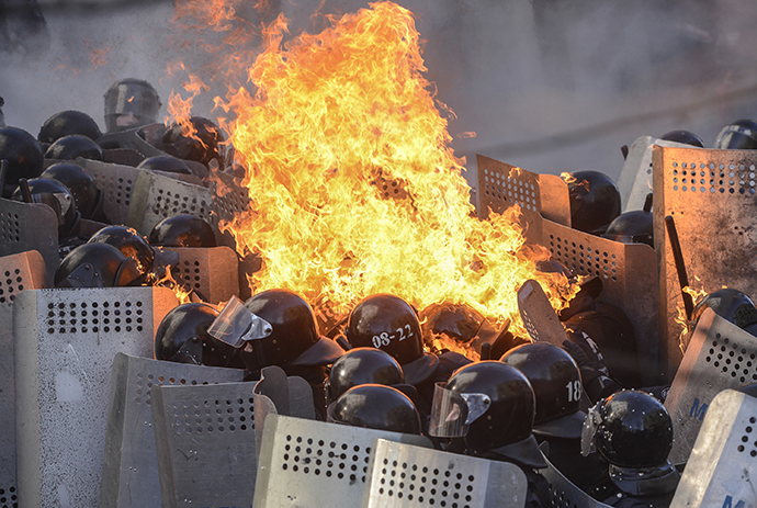Interior Ministry members are on fire, caused by molotov cocktails hurled by anti-government protesters, as they stand guard during clashes in Kiev February 18, 2014. (Reuters / Andrew Kravchenko)