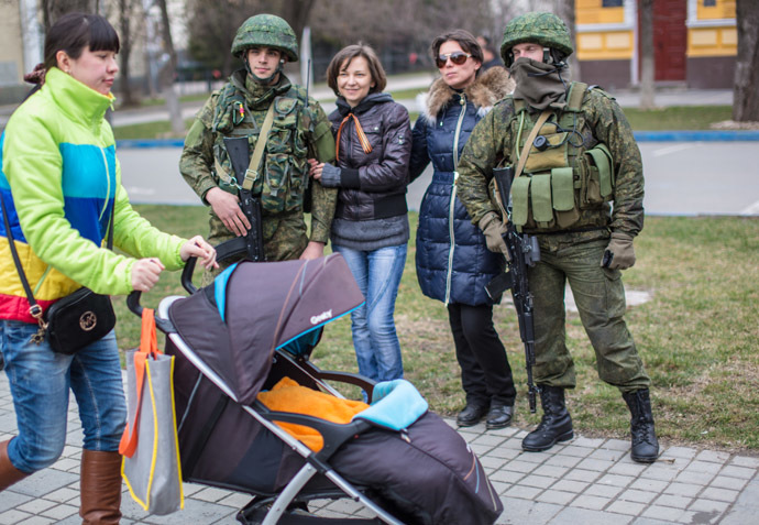 Residents of Simferopol pose for a photograph with soldiers. (RIA Novosti/Andrey Stenin)