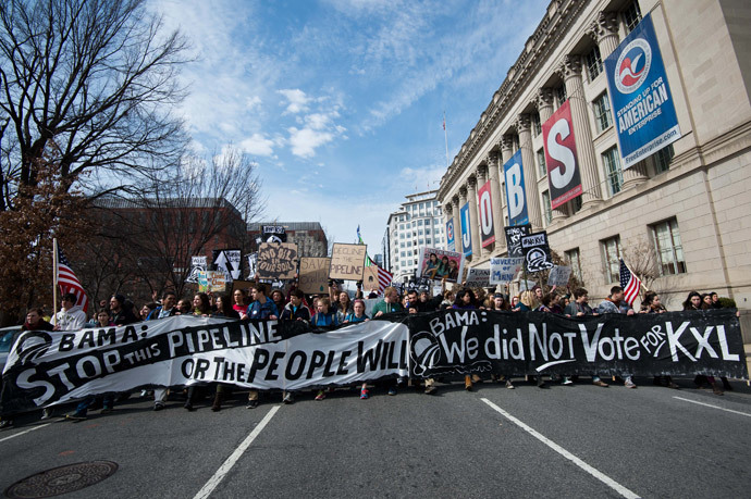 Students protesting against the proposed Keystone XL pipeline march past the US Chamber f Commerce near the White House in Washington,DC on March 2, 2014.(AFP Photo / Nicholas Kamm)