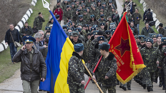 Ukrainian servicemen carry flags as they leave Belbek Airport in Crimea on March 4, 2014. (Reuters / Baz Ratner)