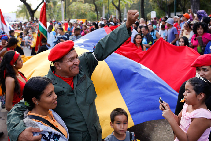 A man dressed as late Venezuelan President Hugo Chavez waves during the Carnival festival in Caracas March 4, 2014.(Reuters / Carlos Garcia Rawlins)