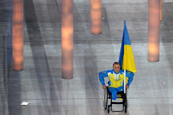 Ukrainian paralympic cross-country skier and biathlete Mykhaylo Tkachenko enters the stadium the Fisht Olympic Stadium during the opening ceremony of the 2014 Winter Paralympic Games in the Black Sea resort of Sochi on March 7, 2014. (AFP Photo / Kirill Kudryavtsev)