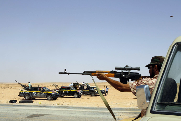 A rebel from Misrata tests his weapon at Bir Doufan check-point about 70 km from Bani Walid (Reuters/Youssef Boudlal)