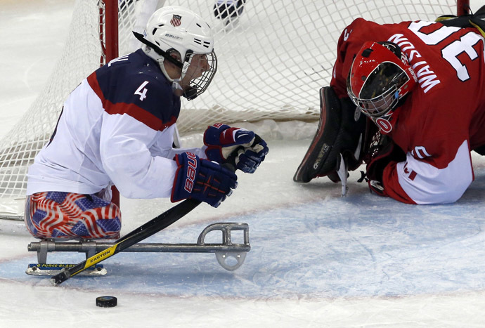 Brody Roybal of the U.S celebrates a goal against Canada's Corbin Watson (R) during the semi-final sledge hockey game at the 2014 Sochi Winter Paralympic Games March 13, 2014. (Reuters)