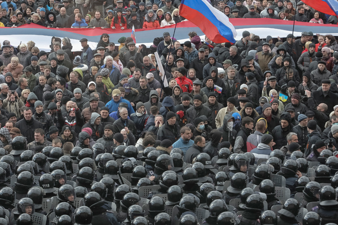 Riot police stand guard in front of a regional government building as pro-Russian demonstrators take part in a rally in Kharkiv March 16, 2014 (Reuters / Stringer)