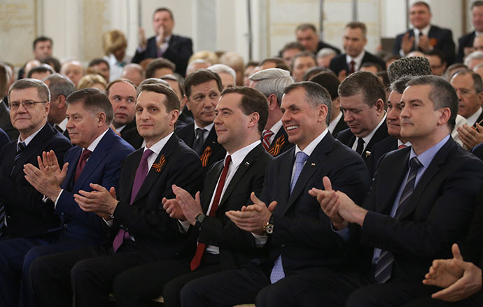 Dmitry Medvedev (third right, foreground), listening to President Vladimir Putin's statement before the assembly of Duma deputies, Federation Council members, the heads of the Russian regions and representatives of civil society. His speech concerned an appeal by the Republic of Crimea and the city of Sevastopol to integrate them with the Russian Federation, March 18, 2014. (RIA Novosti / Ekaterina Shtukina)