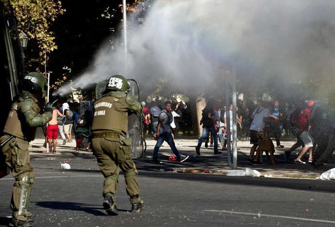A water cannon disperses demonstrators during a protest to demand free and good quality education and a call for a Constituent Assembly, in Santiago, on March 22, 2014. (AFP Photo / Martin Bernetti)