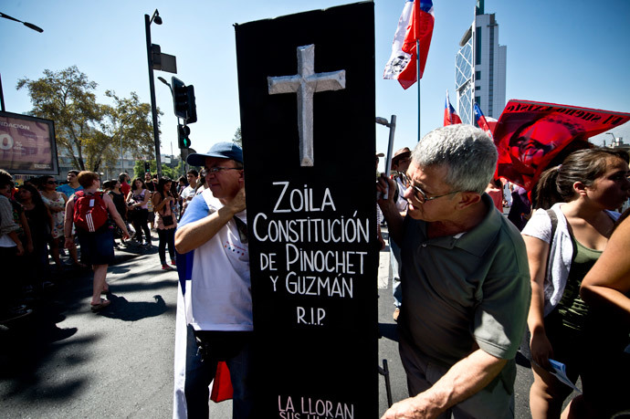 People take part in a protest to demand free and good quality education and a call for a Constituent Assembly, in Santiago, on March 22, 2014. (AFP Photo / Martin Bernetti)