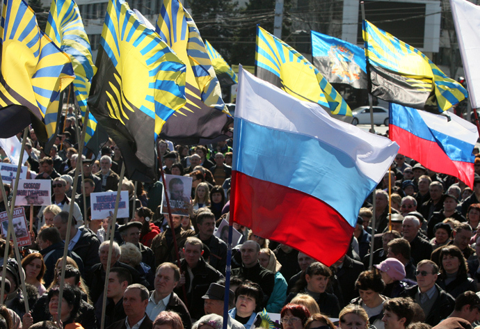 Pro-Russian protesters wave Russian flags along with the flags of the Donetsk region during a rally in the eastern Ukrainian city of Donetsk on March 23, 2014 (AFP Photo / Alexander Khudoteply)