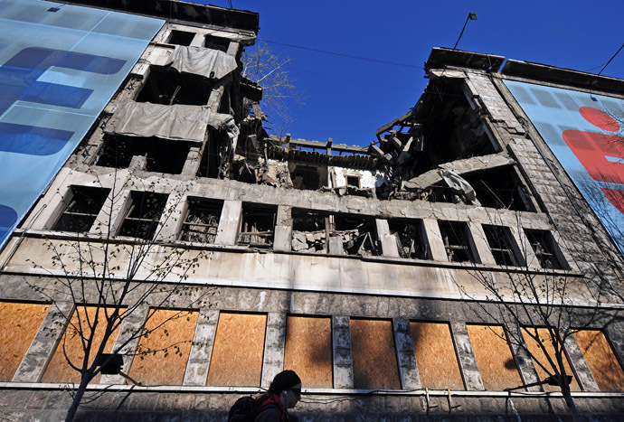 A woman walks in front of the former federal Interior Ministry in Belgrade, destroyed by NATO March 22, 2014. (AFP Photo)