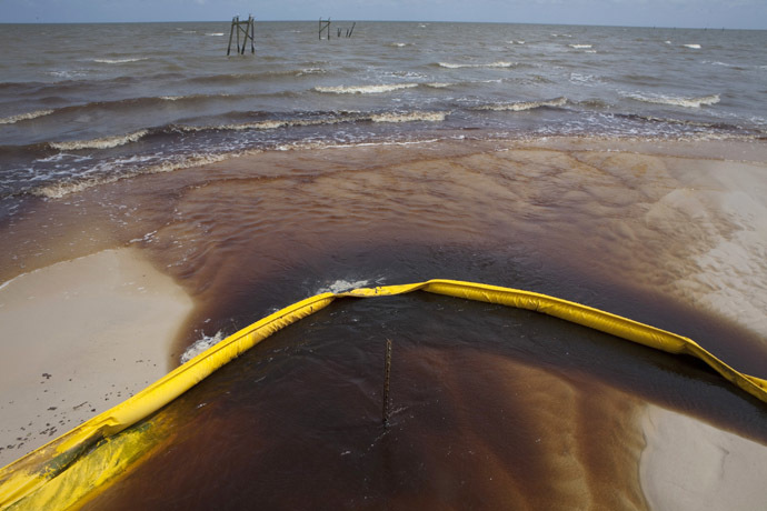 A protective boom is seen as oil from the Deepwater Horizon spill recedes back into the Gulf of Mexico after washing into a drainage canal in Waveland, Mississippi July 7, 2010. (Reuters/Lee Celano)