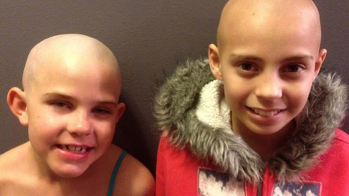 School reverses suspension of student who shaved her head for friend with cancer