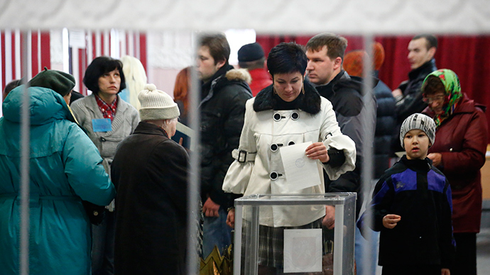 A woman is reflected in a mirror as she casts her ballot during voting in a referendum at a polling station in Simferopol March 16, 2014 (Reuters)