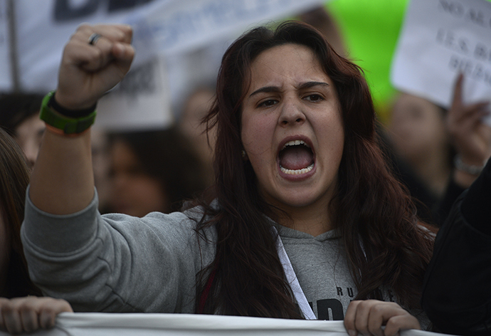 A student reacts as she demonstrates in the streets of Madrid marking the second day of strikes against the government's cuts in education spending on March 27, 2014. (AFP Photo / Pierre-Philippe Marcou)