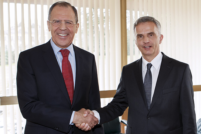 Russian Foreign Minister Sergei Lavrov (L) shakes hands with Swiss President Didier Burkhalter (R), whose country currently holds the OSCE (Organization for Security and Co-operation in Europe) rotating presidency, prior to their meeting on the sidelines of the United Nations (UN) Human Rights Council session on March 3, 2014 at the UN headquarters in Geneva. (AFP Photo / Salvatore Di Nolfi)