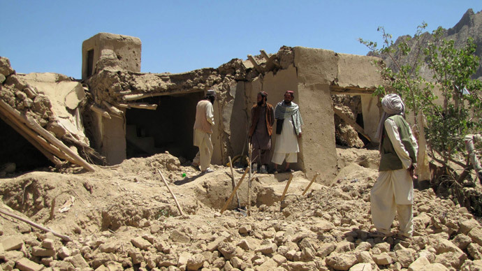 Afghan villagers stand at a house which was hit by a NATO airstrike in Sajawand village in Logar province, south of Kabul on June 6, 2012.(AFP Photo / Sabawoon Amarkhil )