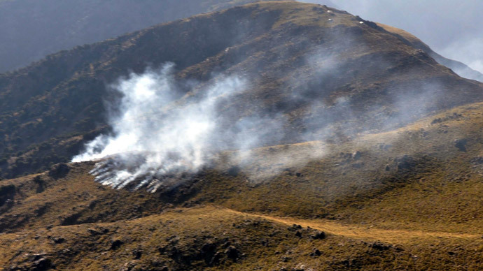 Smoke rising apparently after a cross-border NATO air strike on Pakistani border posts on a mountain in the Mohmand tribal district, on November 26, 2011.(AFP Photo / ISPR)
